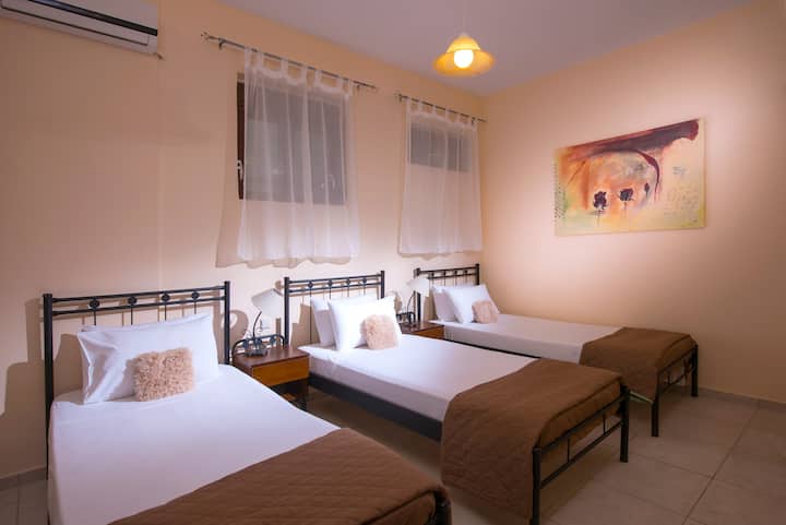 One of the 2 bedrooms with 3 single beds