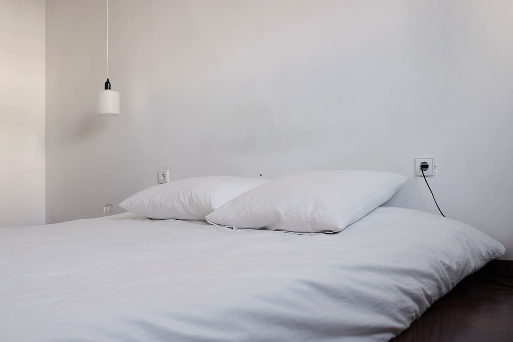 A double mattress spacious bed over a tatami base.
