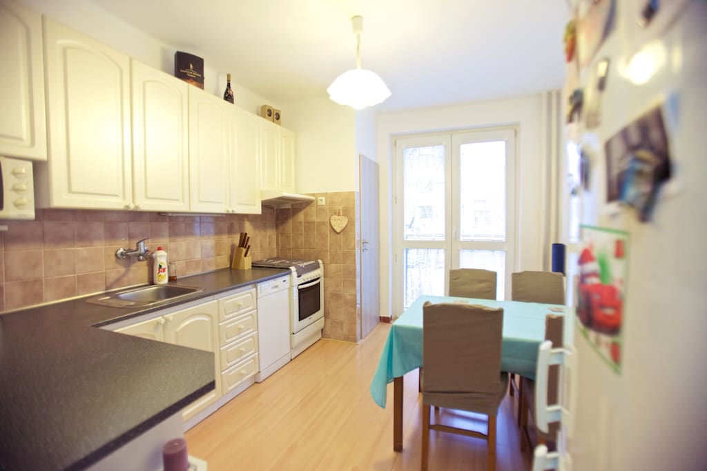 Kitchen with 4 seating, stove, fridge, balcony