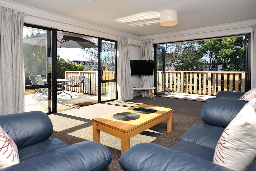 The sunny living area opens onto the deck
