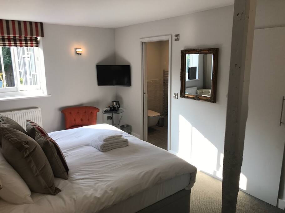 View as you walk in, bed, TV, tea & coffee facilities and bathroom.