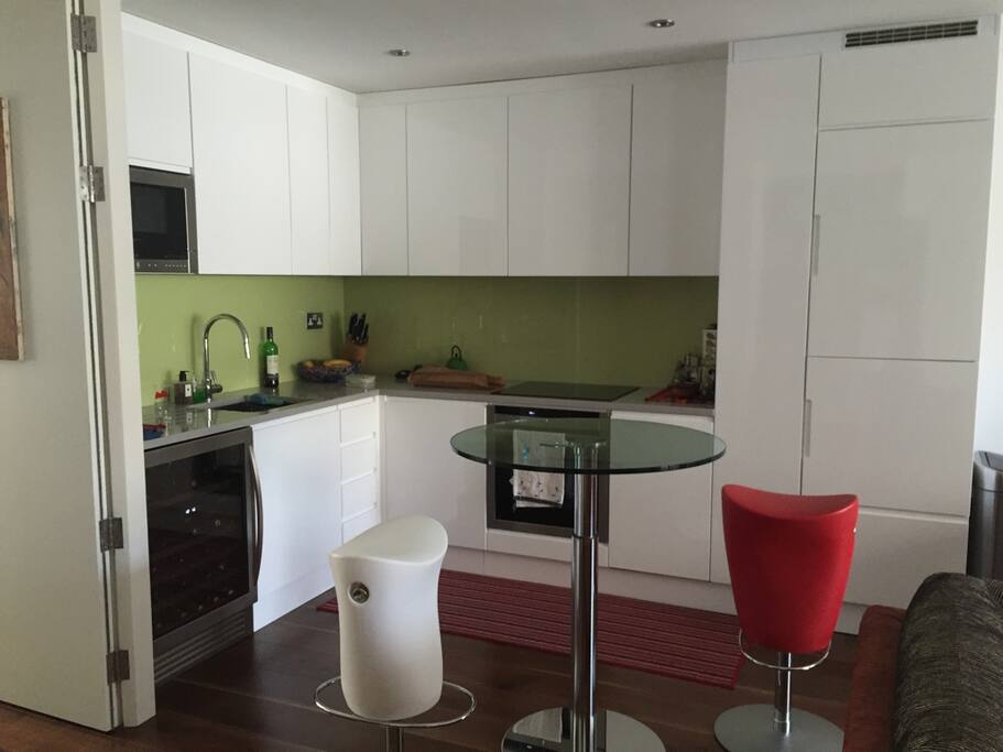 Kitchen with bar table and stools