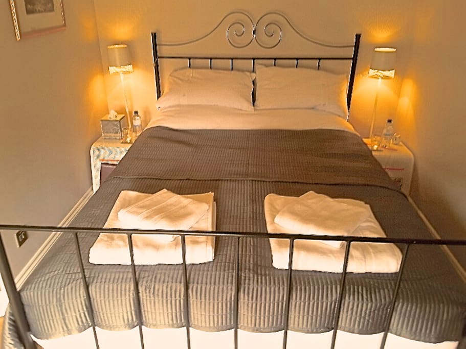 Room with wrought iron Kingsize Bed and ensuite