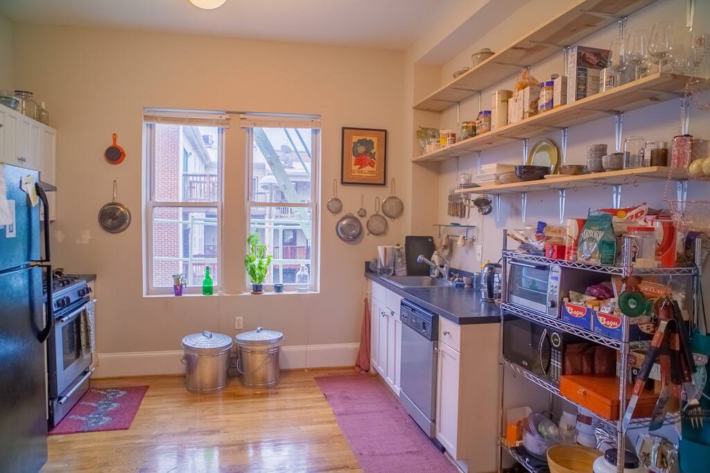 Gas range, variety of pots & pans, and too many utensils.