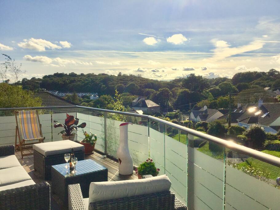 The west facing balcony looks over the village towards the woods. There is comfortable outdoor seating and it is a perfect spot to enjoy a glass of wine in the last of the evening sunshine,