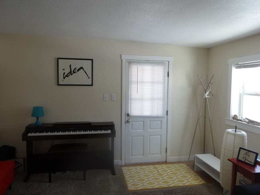 Sunny living room with electric piano