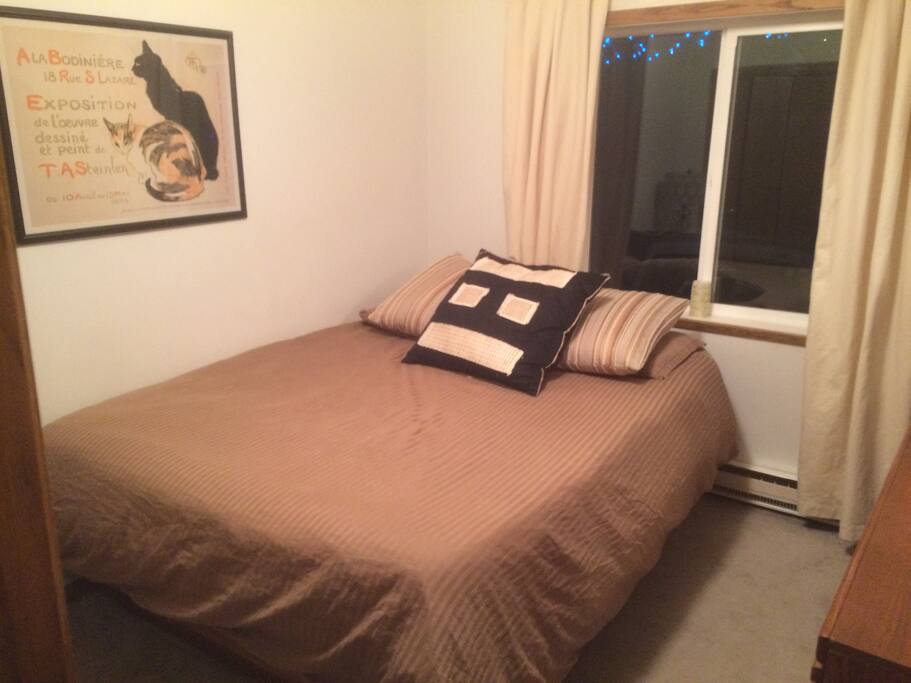 Cozy room with queen bed and television
