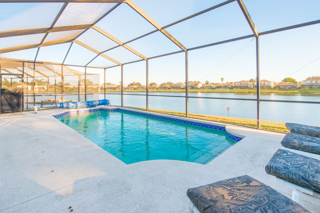 Screened in pool overlooking lake w/automatic awnings for shade.