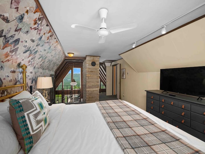 View from the master bedroom! Custom mountain wallpaper and new carpet - cozy loft bedroom open to living area but screen provided and privacy is easy to obtain. En suite bath on the loft level. 