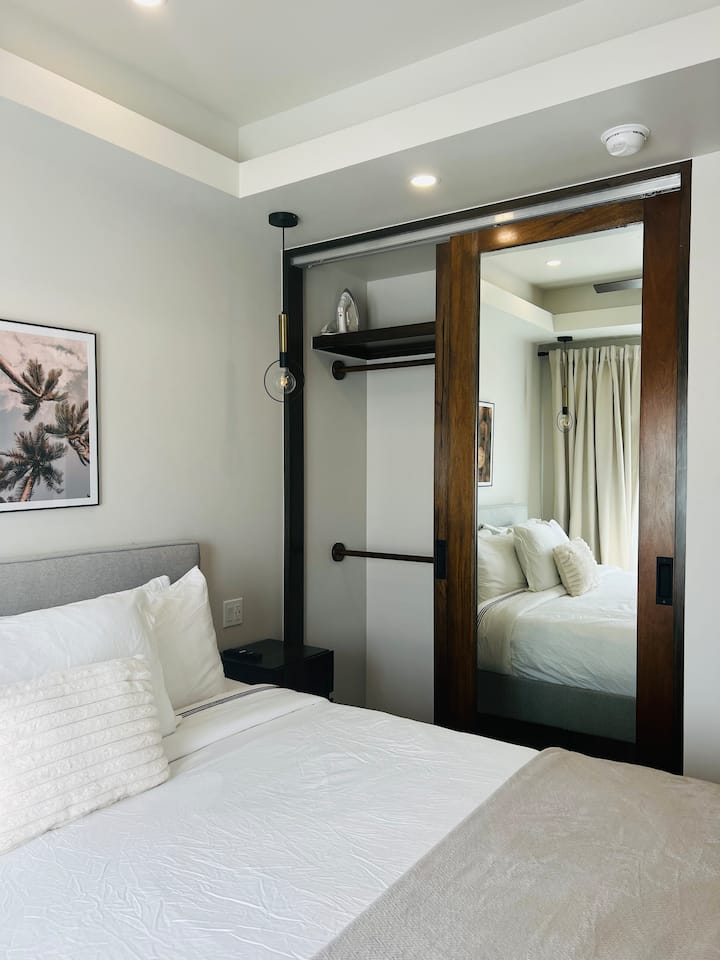 1st bedroom with a safe and TV