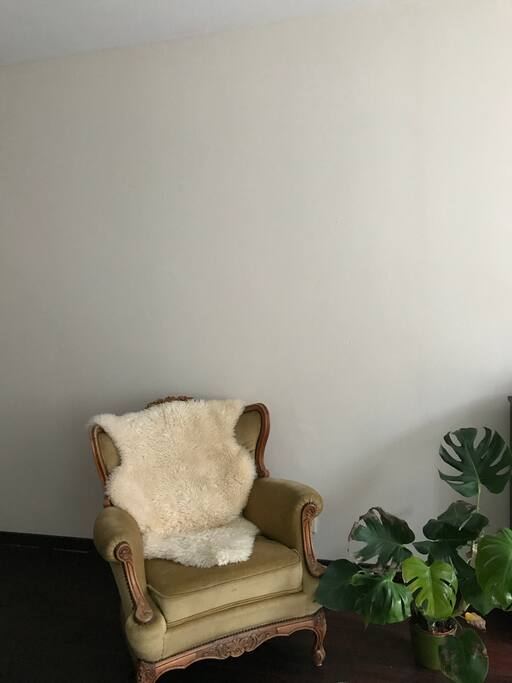 A comfortable chair for reading a book with direct light from the 3 large windows