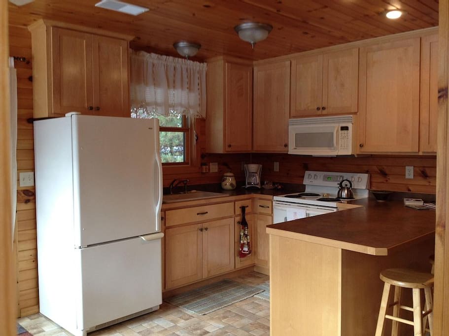 The full kitchen includes cookware, dishes, and pantry.