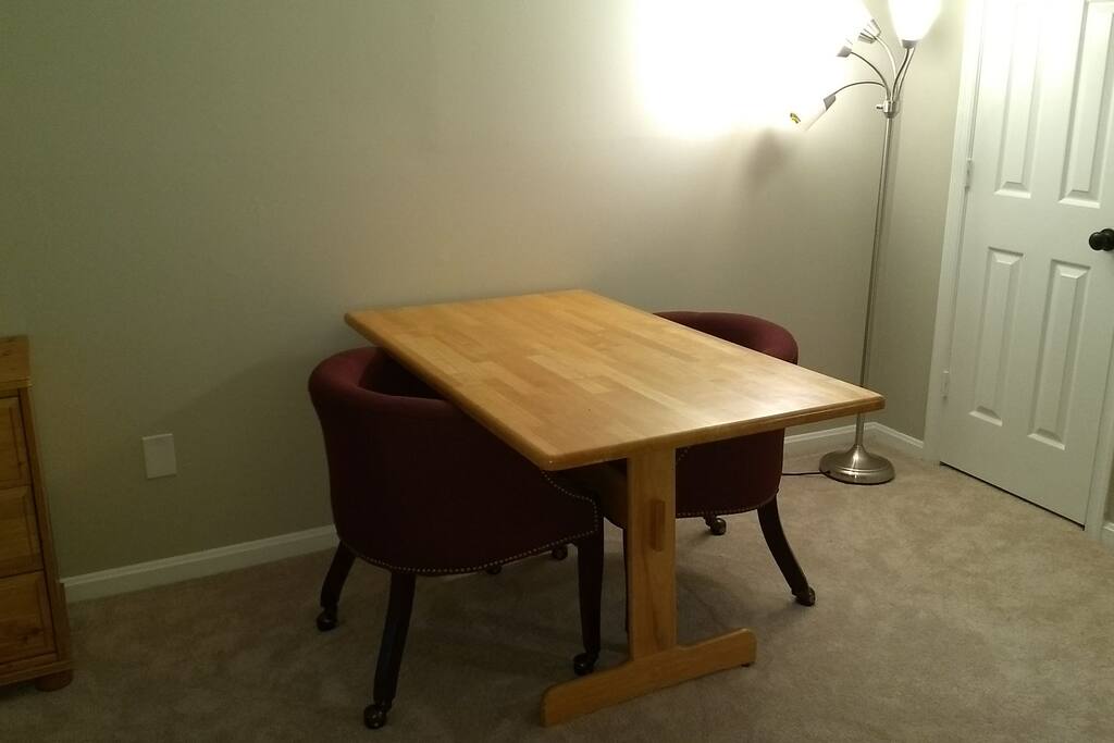 A large table with two soft chairs.
