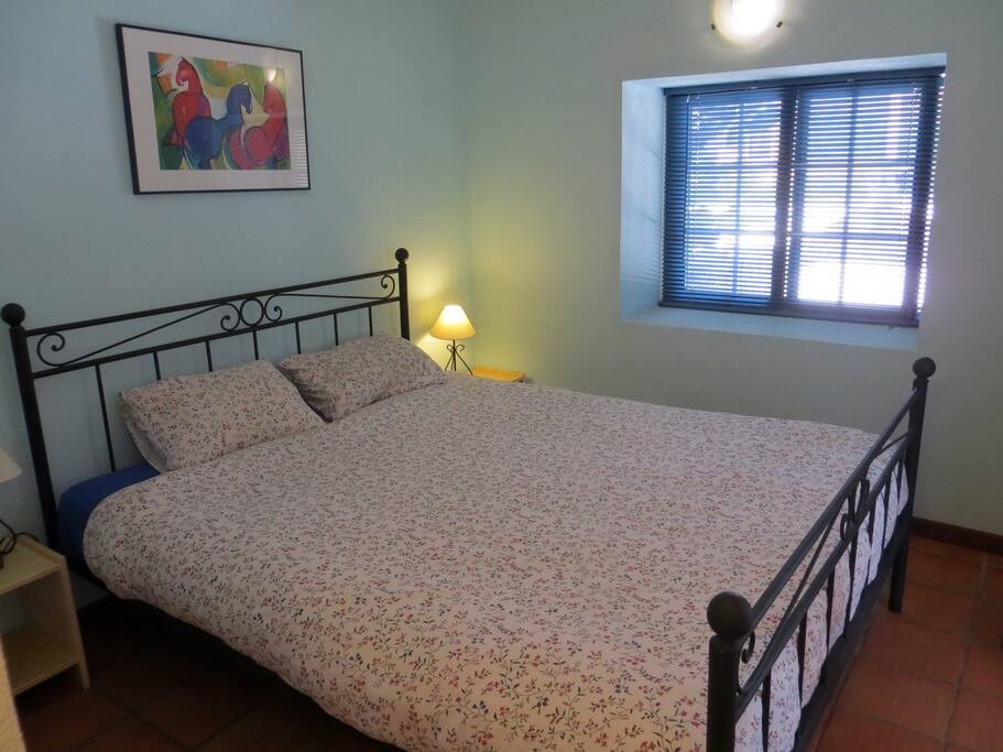 Cozy bedroom with double bed and wash basin