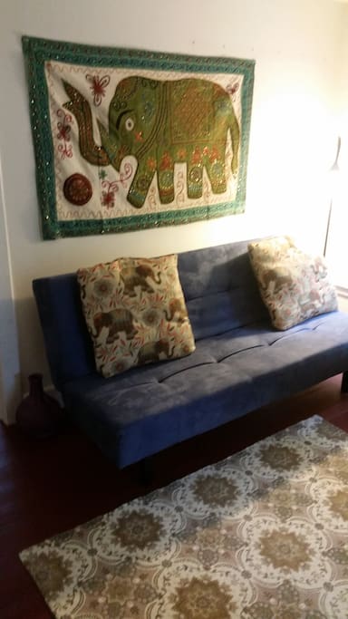 Living room space futon folds out into full size sleeping space.
