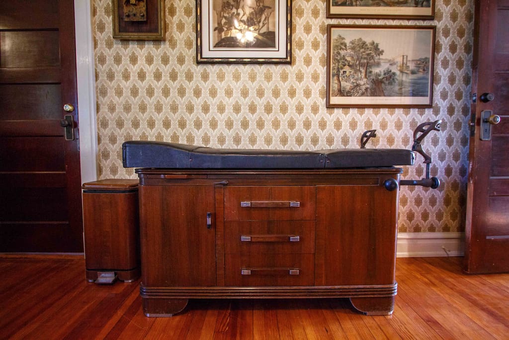 Quirky vintage decor such as this exam table which can be used as a luggage rest!