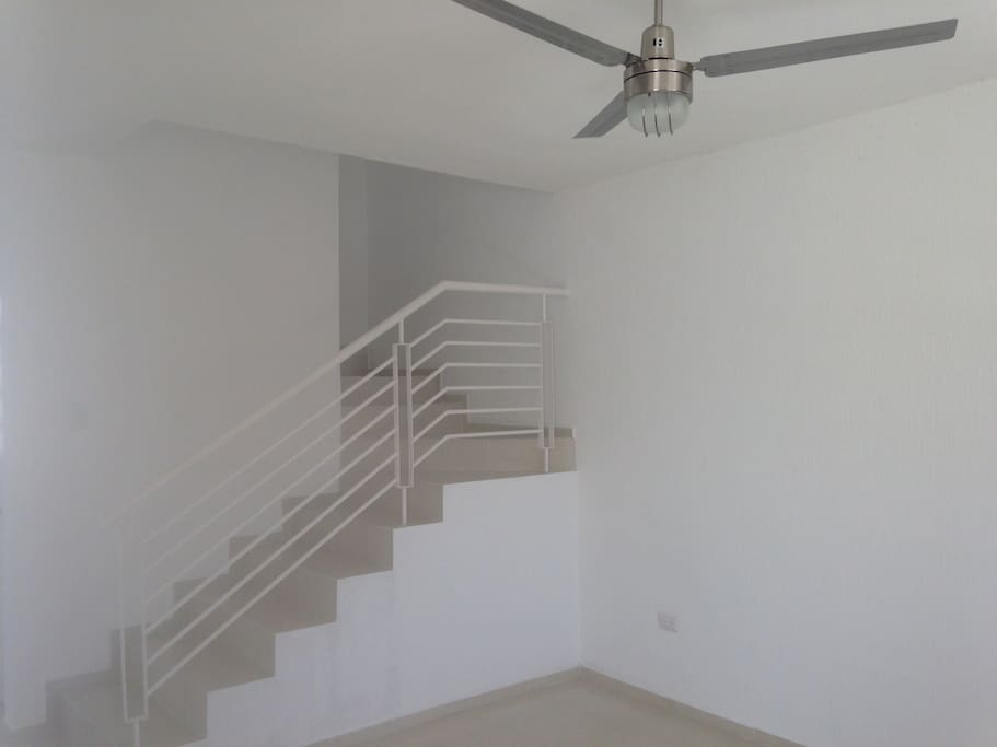Living Room - Main Stairs. Ceiling Fans included (2 on Main Floor)