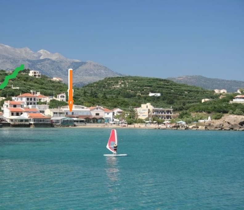 Almyrida bay beach, yellow arrow points the apt.