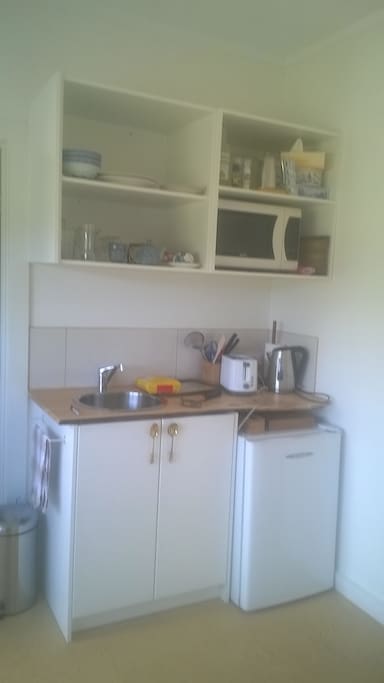 functional kitchen and meals area seats 3