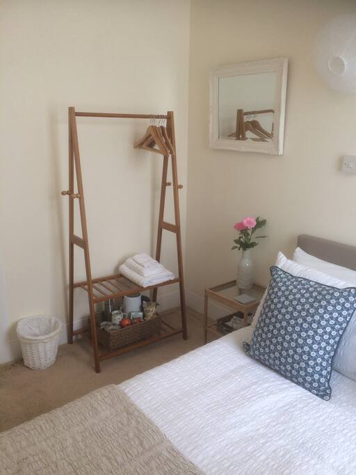 Hanging space, bedside table, mirror and an over bed light