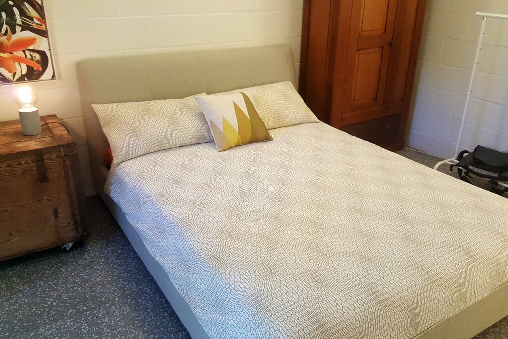 The bed is in the middle of a spacious bedroom with sliding glass doors (and security insect screen) letting in plenty of light. Double blinds block out the light if preferred.