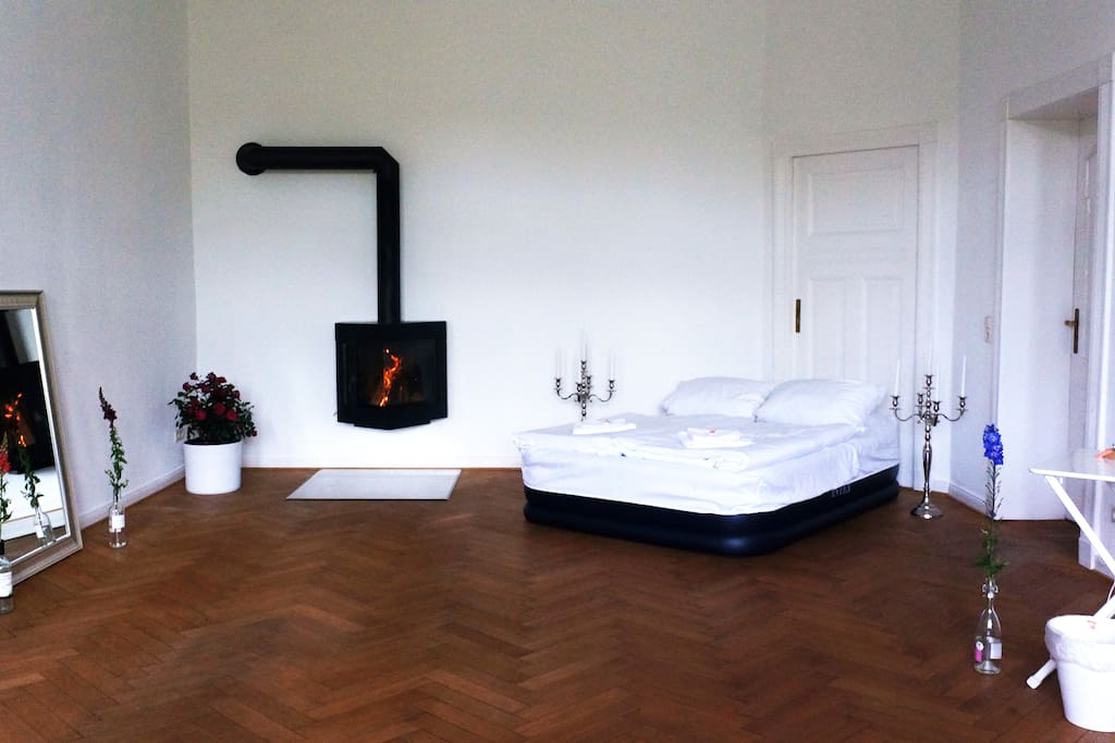 The comfy air bed next to the fire place.