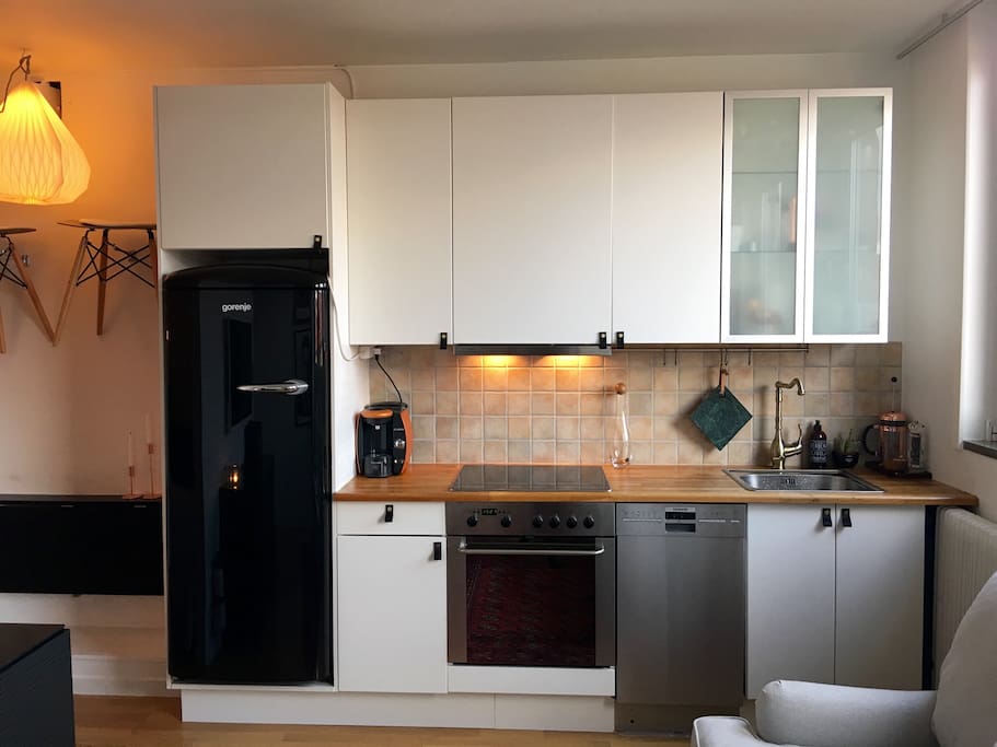 Full kitchen with stove, owen, dishwasher, microwave and coffee machine.