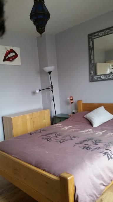 A light and bright spacious bedroom with generous storage space including a walk in wardrobe