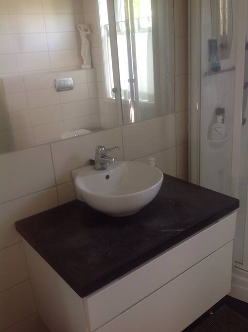 Bathroom with washing machine and shower