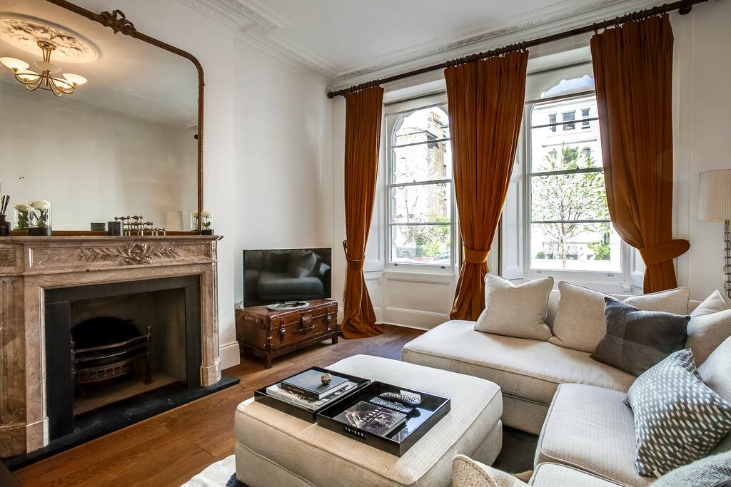 The living area has wonderful windows and sleek wooden floors.