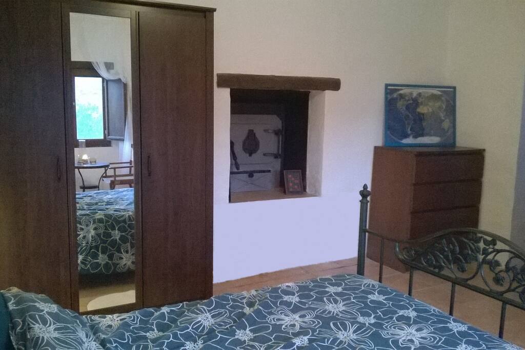 Bedroom with back of the old bakery oven.