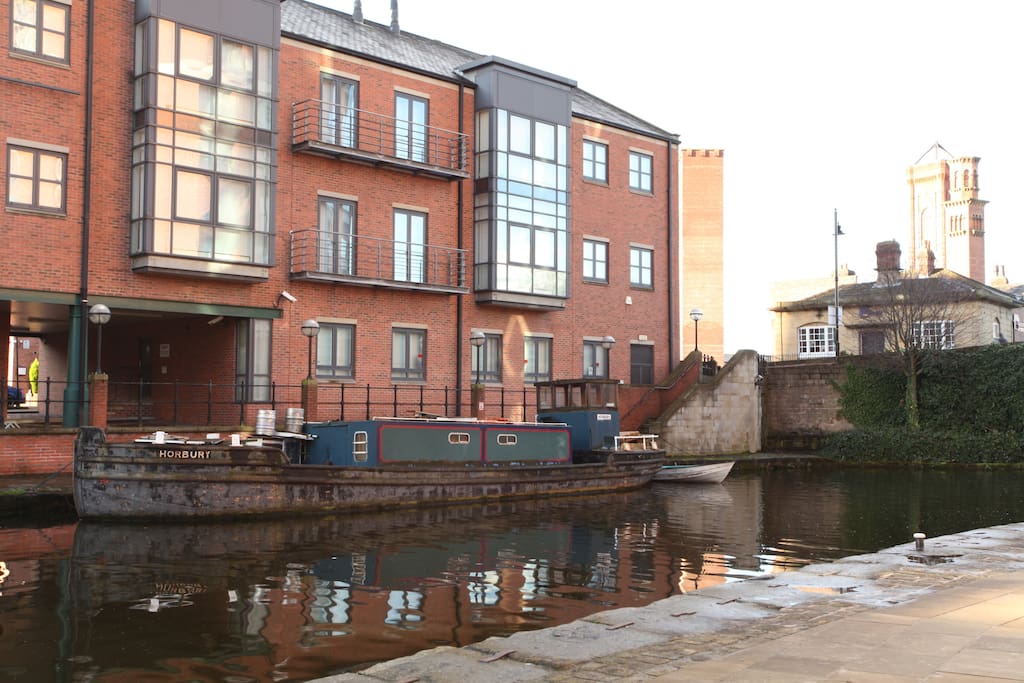 The picturesque canal with long boats moored just outside the front door