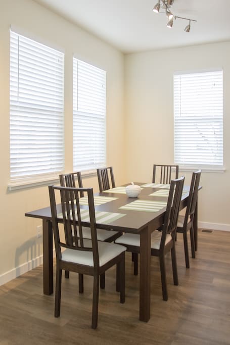 The dining room has many windows for natural daylight as well as a modern lamp to offer plenty of light in the evening. Enjoy your family dinner here with seating up to 10!