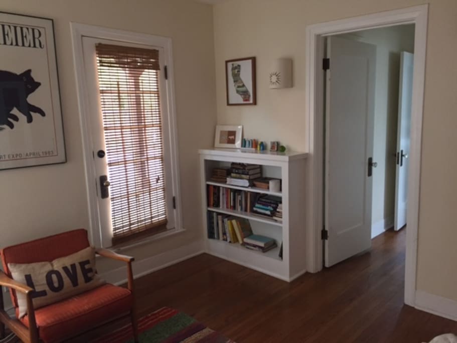 other view of living room and door that opens to the large deck