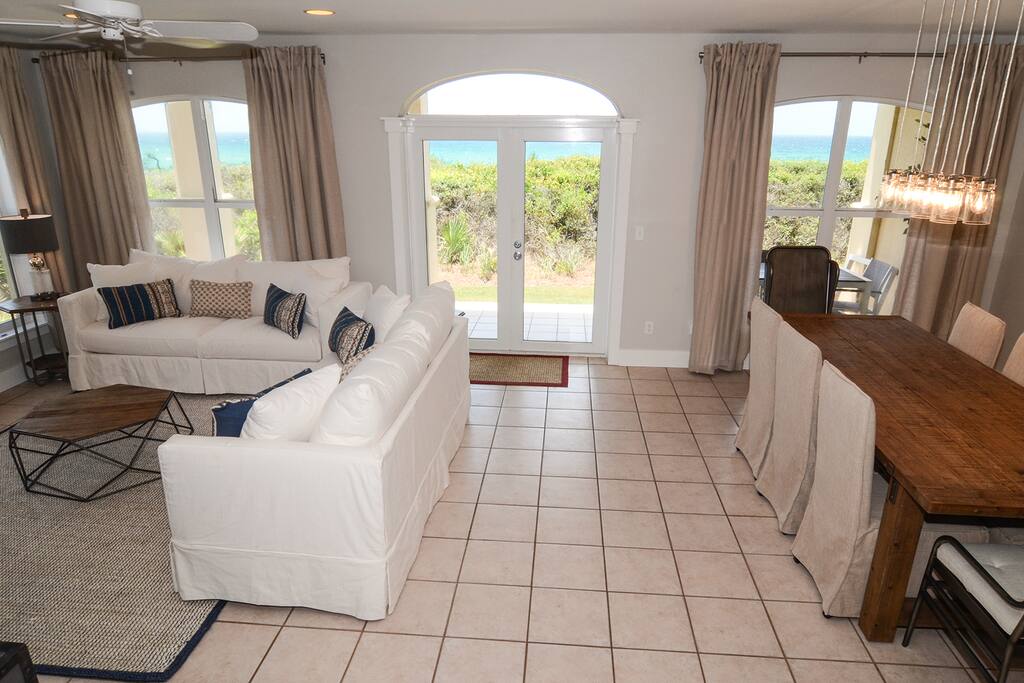 Cozy living and dining areas with french doors leading out to the covered patio