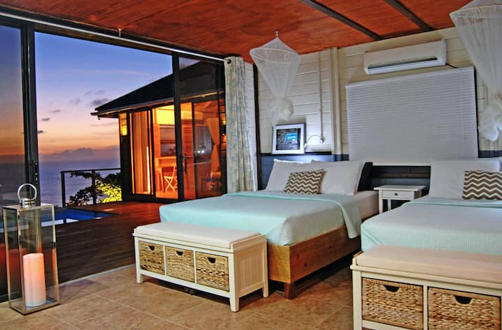 Spacious main bedroom with two queen size beds, private en suite, A/C and an oversized bay window for sunsets...