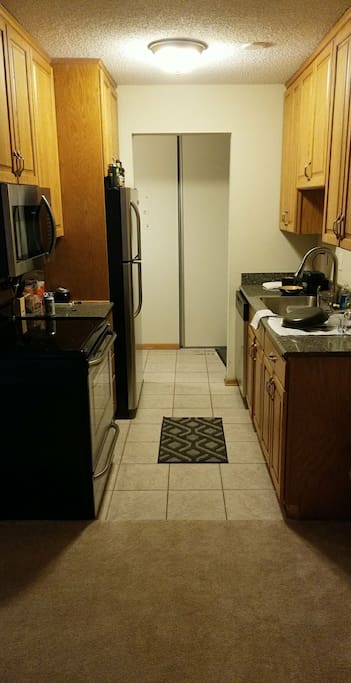 Kitchen area, with full appliances - microwave, oven/stove and dishwasher.