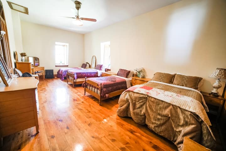 The Storage Room Bedroom has two single beds and two double beds.  The windows open to the front of the house on the west and the north yard.