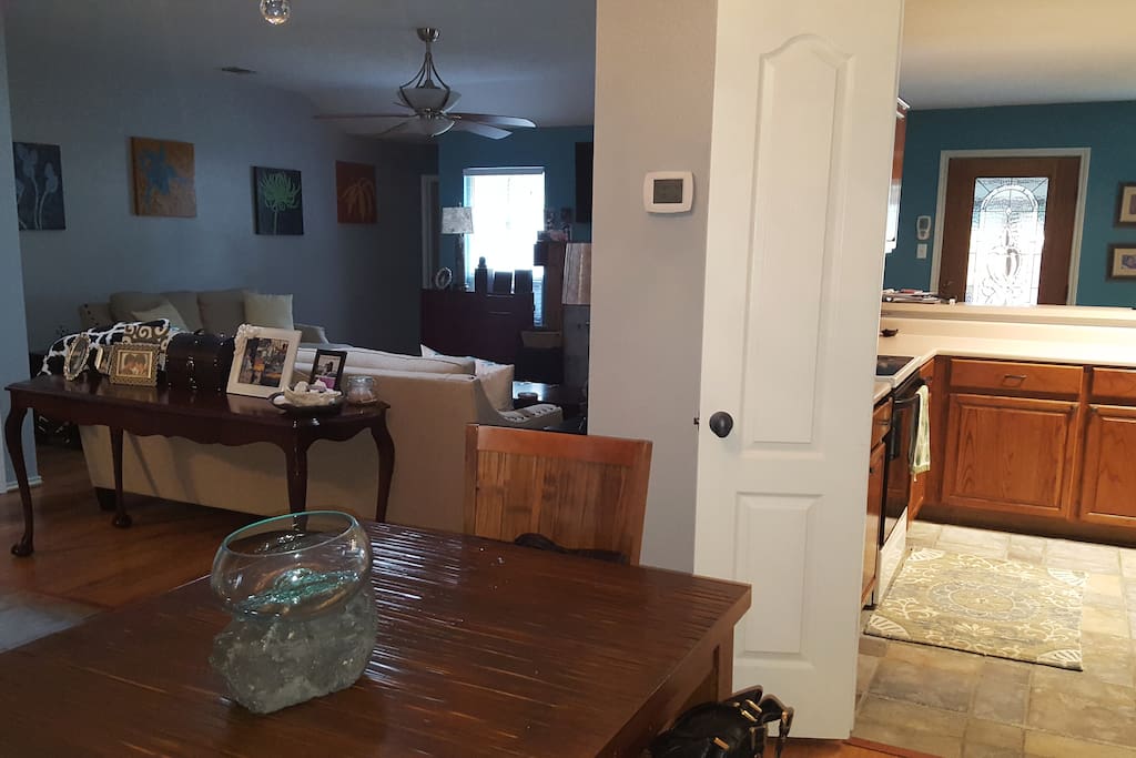 Small dining table connecting back entrance for kitchen through the living room.
