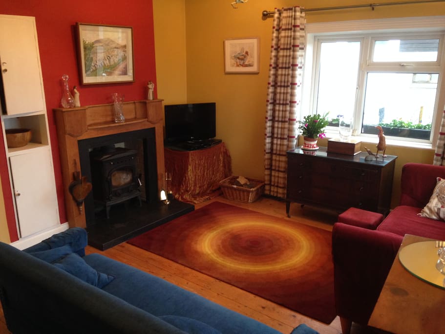 Cosy living room with wood fire stove, TV (net flicks, DVD) and Piano.