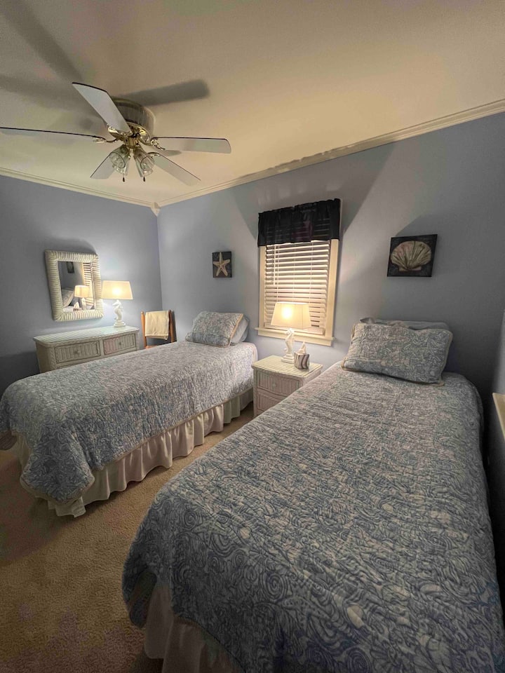 Back bedroom offers extra long twin beds which can easily become a king size for your comfort and convenience. Plenty of room for a pack and play. 