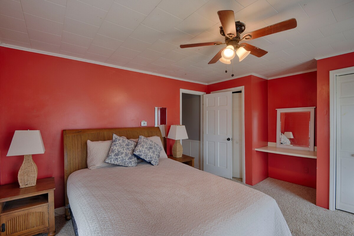 Bedroom 2 in front of house with queen bed and 2 closets (1 cedar)
