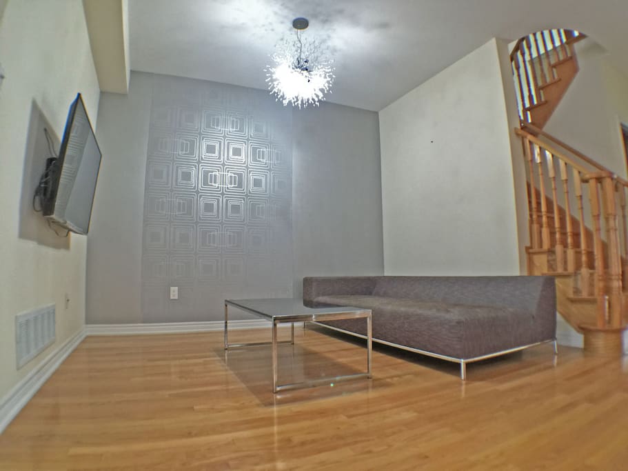Living room has designer chandelier.