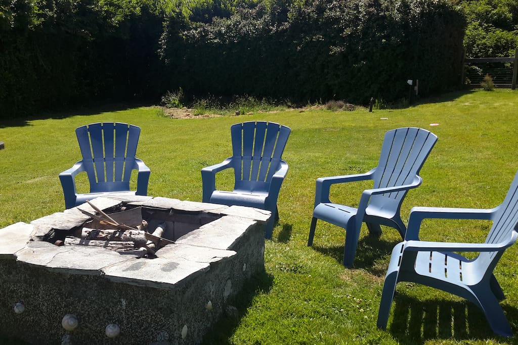 Large fenced and gated yard with fire pit.