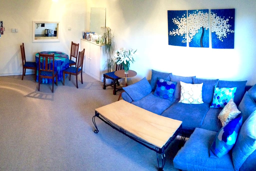 Lounge view from large double windows facing views of greenery & trees