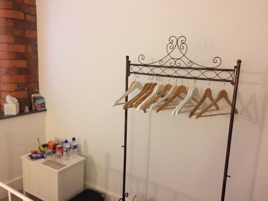 Clothing rail and hangers. Storage unit with snacks, drinks and fruit on top of it :-)