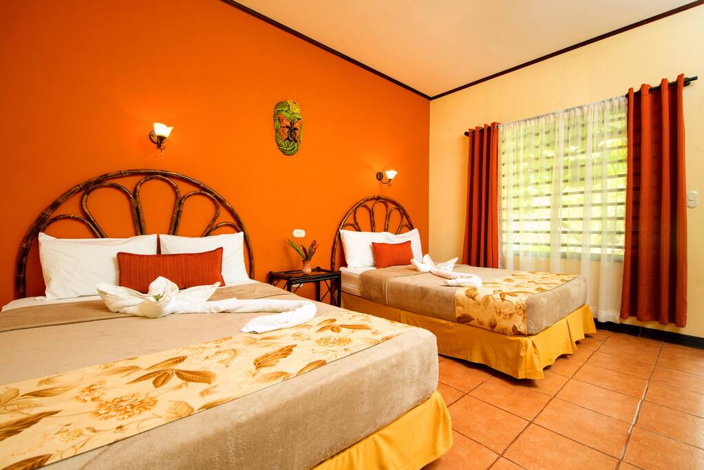 Habitación con 2 camas matrimoniales, baño privado, pantalla plana 32, canales por cable, WiFi gratis, aire acondicionado, ventilador de techo y vistas al jardín