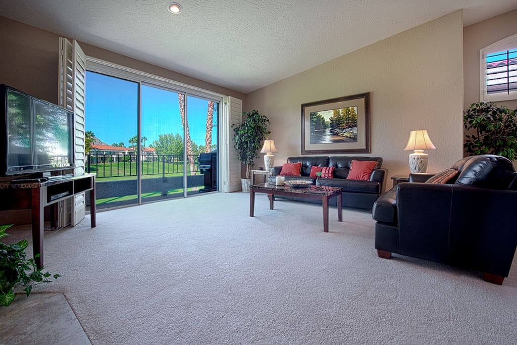Living Room with HGTV and view of golf course and mountains
