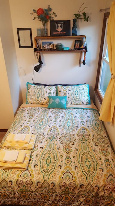 Bright and comfy bedspread and pillows.