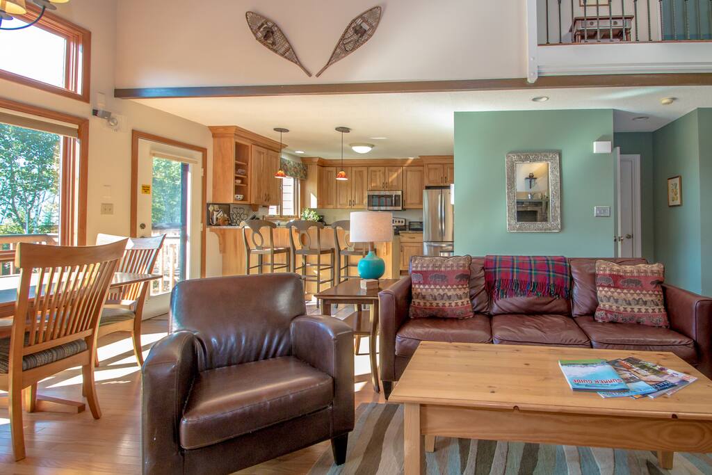 Main level living space view to fully equipped kitchen